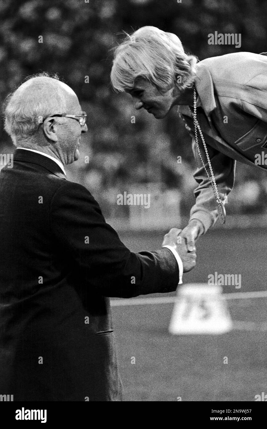 IOC President Avery Brundage shakes hands with West German athlete