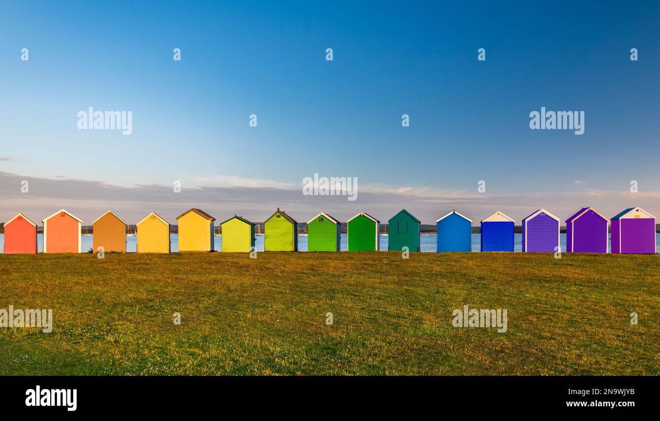 Rainbow of multi coloured beach huts at Hamworthy in Poole, Dorset Stock Photo