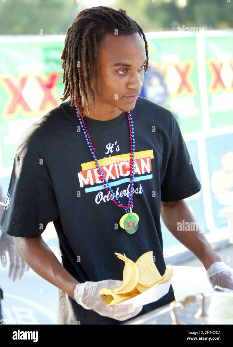 A worker serves nachoes at On The Border's Cinco de Mayo Party on May 5