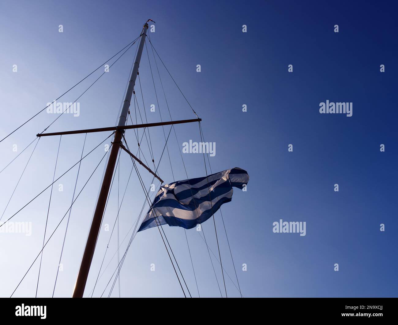 Greek flag floating in a sailing boat Stock Photo