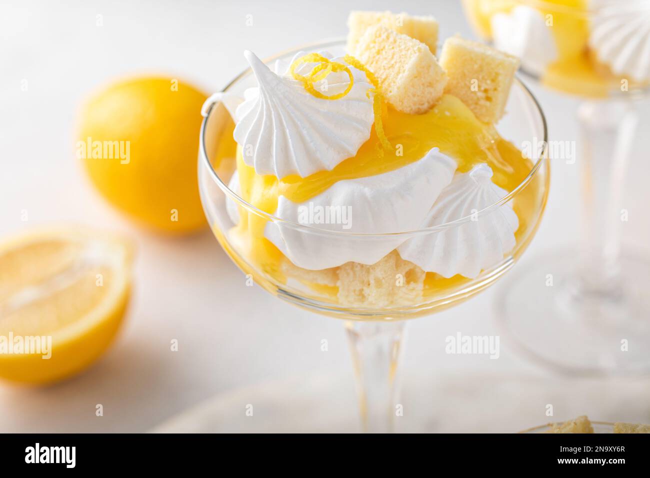 Lemon parfait with pound cake, lemon curd, whipped cream and meringue kisses Stock Photo Alamy