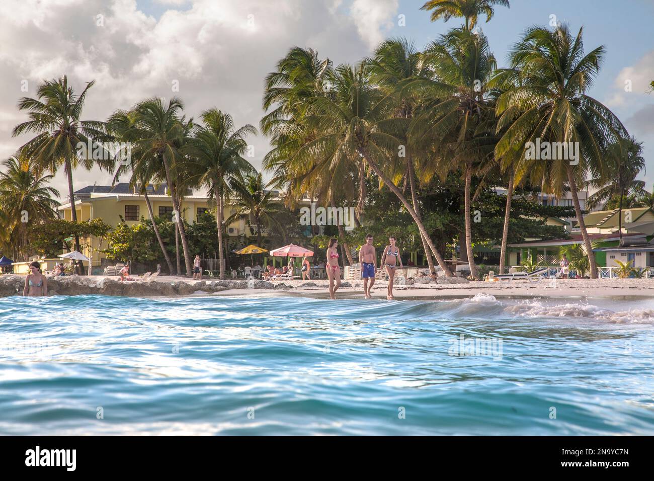 Tourists enjoy a tropical beach at the small village of Worthing, Barbados; Worthing, Barbados Stock Photo