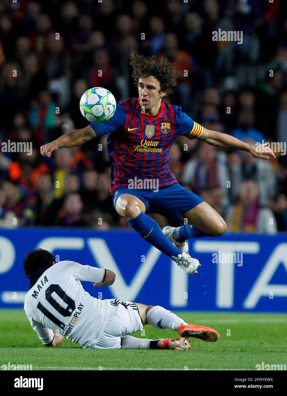 Chelsea's Juan Mata from Spain, bottom, vies for the ball with Barcelona's  Carles Puyol during a Champions League second leg semifinal soccer match at  Camp Nou stadium, in Barcelona, Spain, Tuesday, April