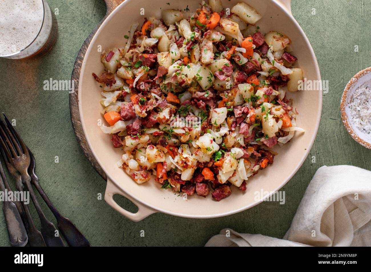 Corned beef hash with potatoes, cabbage and carrot in a cast iron pan