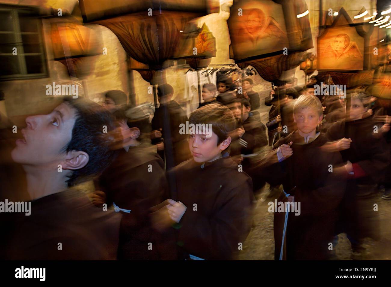 Over 700 children carry hundred year old candlelit lanterns made of