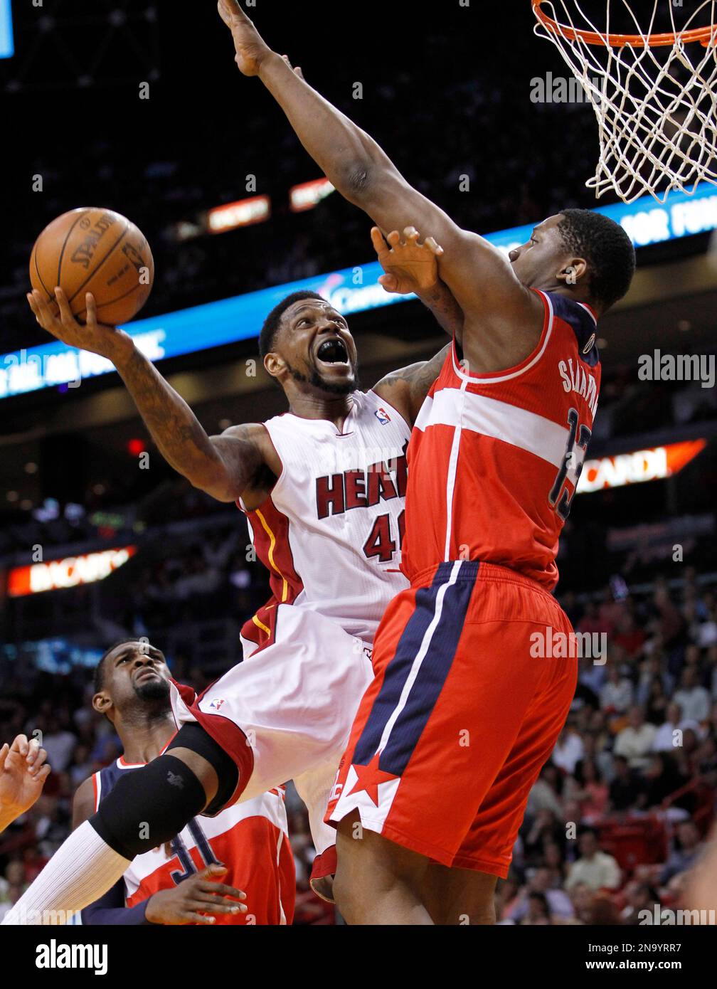 Miami Heat's Udonis Haslem (40) drives to the basket as Washington