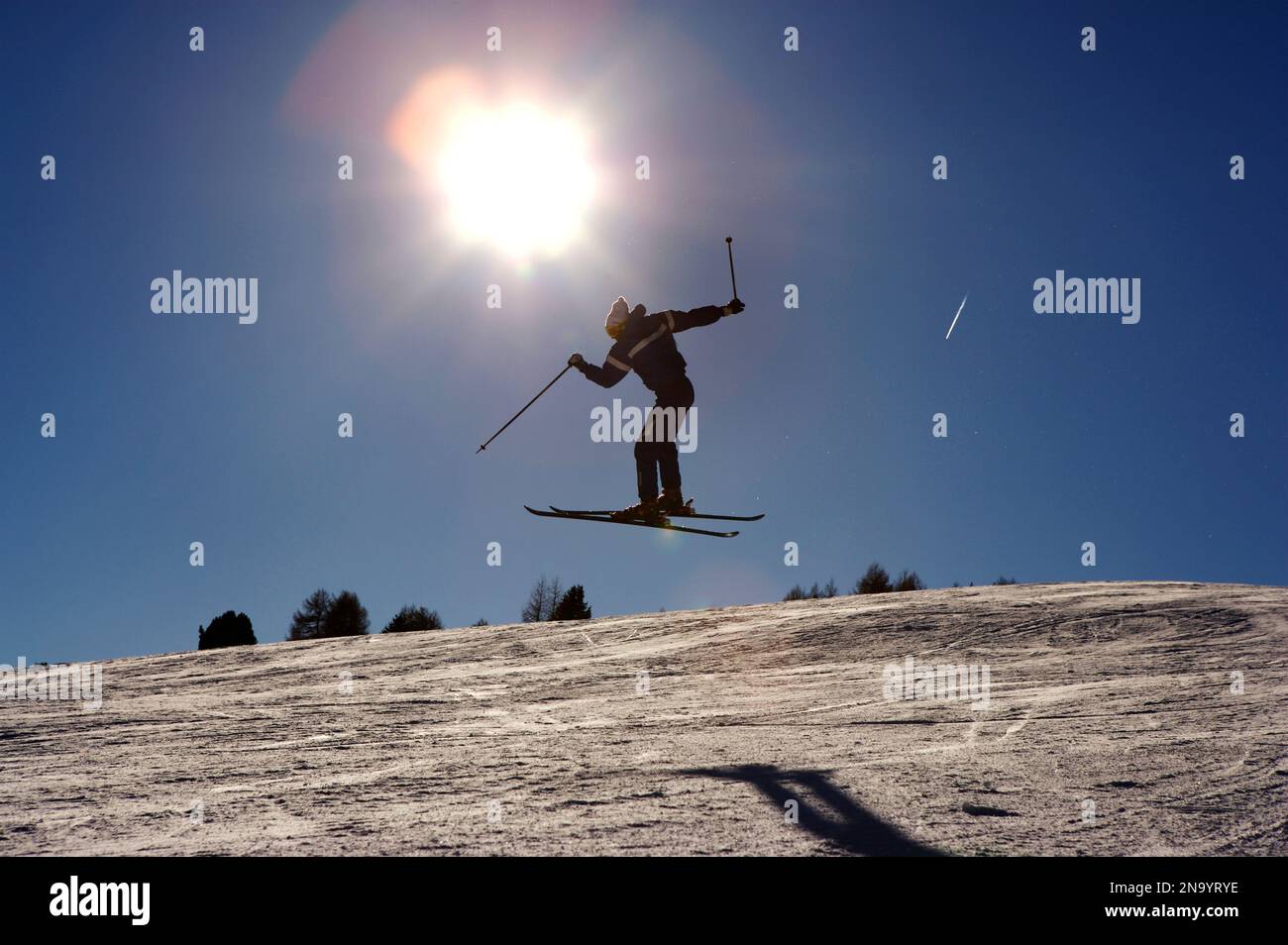 Skier taking a jump at the Siusi ski area in Italy; Seis am Schlern, South Tyrol, Italy Stock Photo