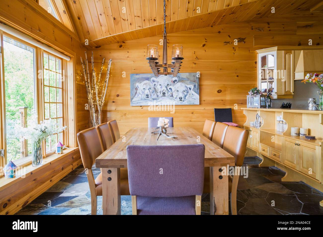 Oak wood dining table with caramel coloured high back leather chairs