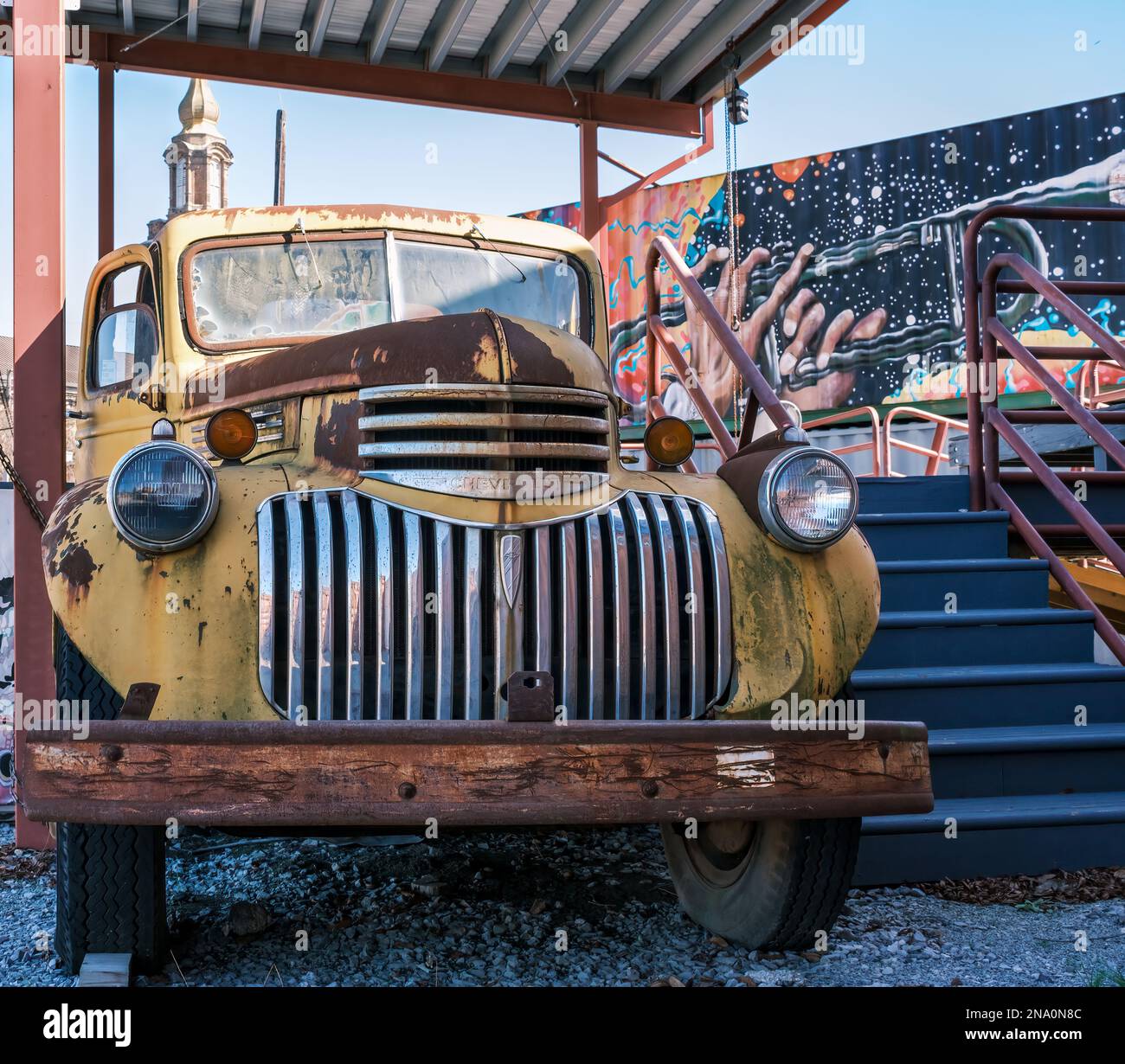 NEW ORLEANS, LA, USA: FEBRUARY 5, 2023: Rusted antique AK series 1940s Chevrolet pickup truck along the stage area of Central City BBQ restaurant Stock Photo