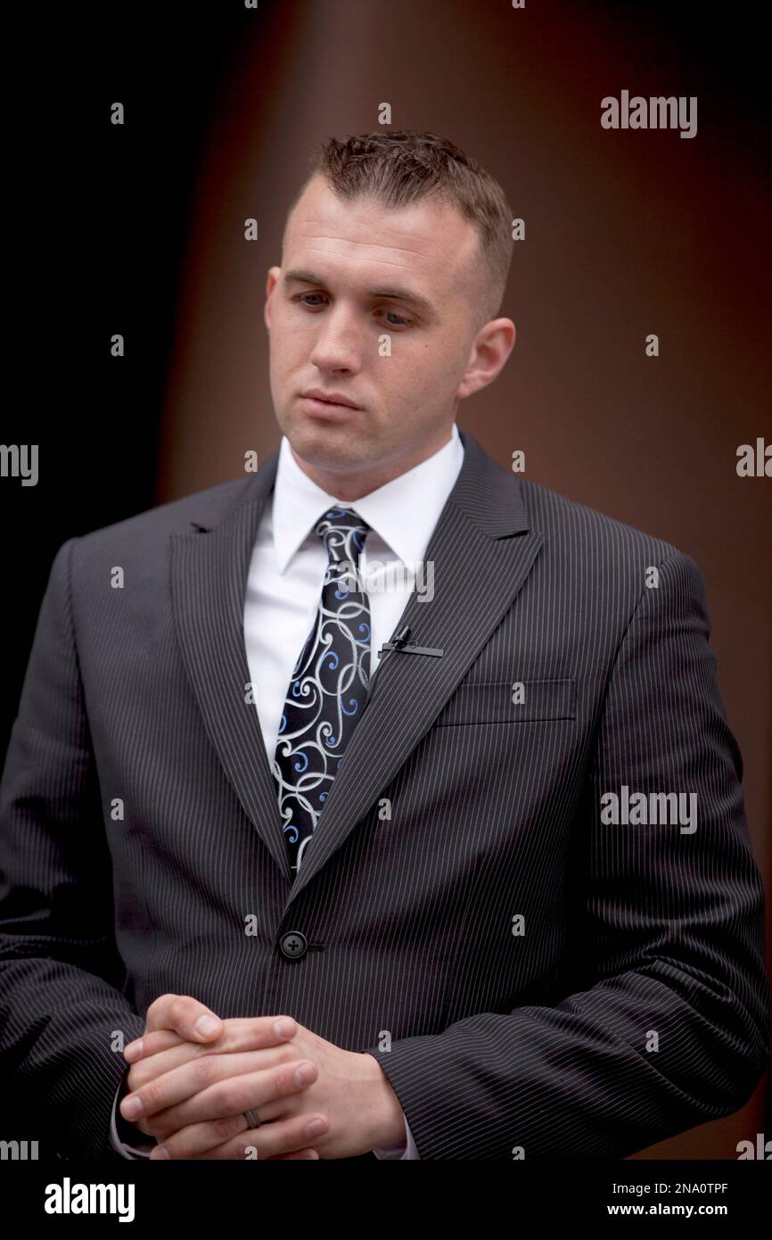 Marine Sgt. Gary Stein speaks with reporters in front of the 