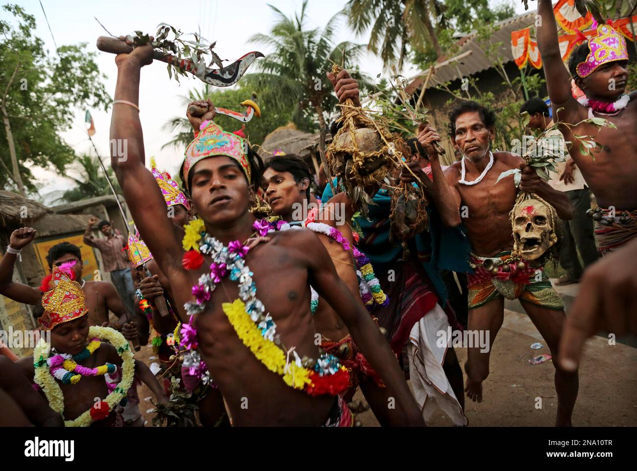 Indian Hindu devotees dance while carrying human skulls during a brief
