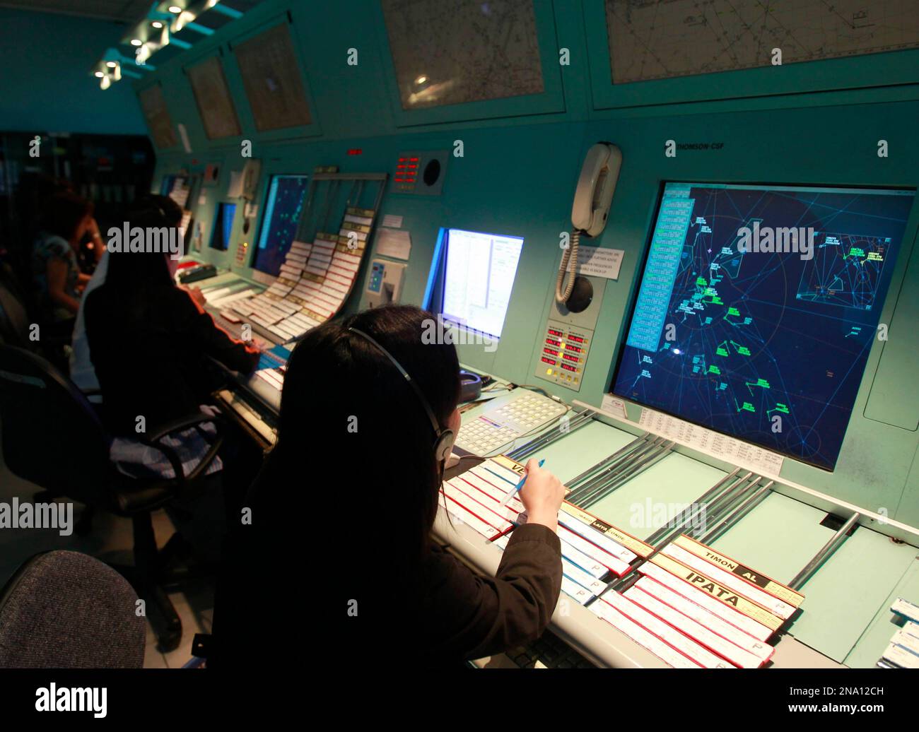Filipino air traffic controllers monitor aircrafts takingoff and