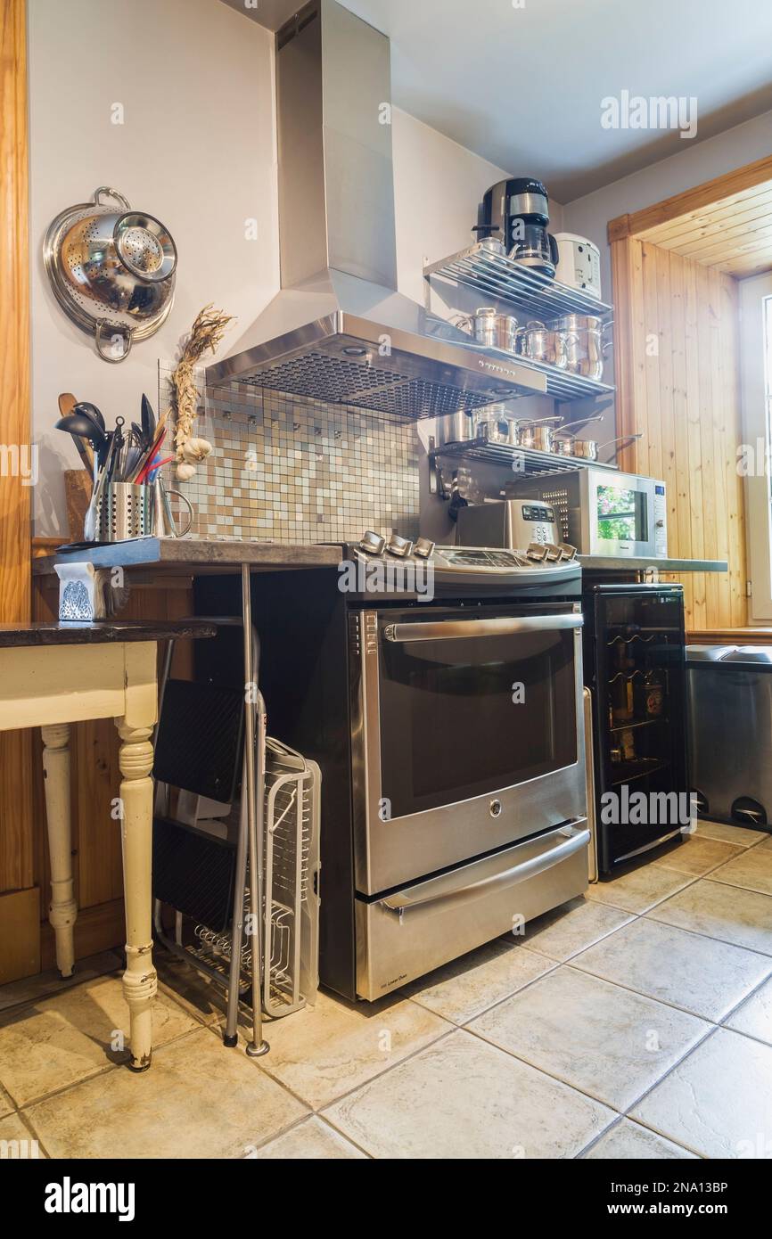 Stainless steel oven in kitchen with ceramic tile floor inside an old ...