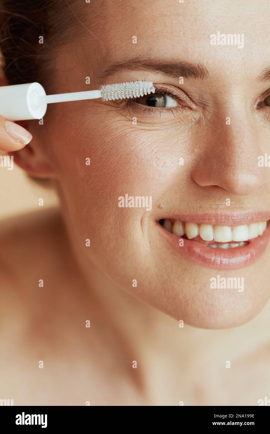 Closeup on 40 years old woman with brow brush. Stock Photo