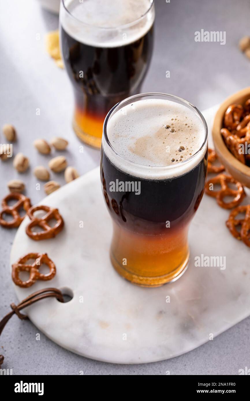 Half and half beer cocktail with lager and dark stout in a beer glass
