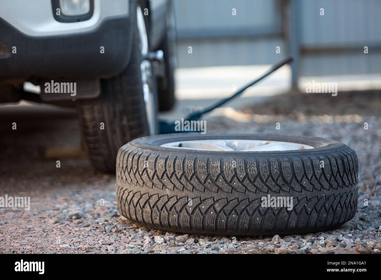 Seasonal winter wheels change. Snow tire lying on ground, is ready to