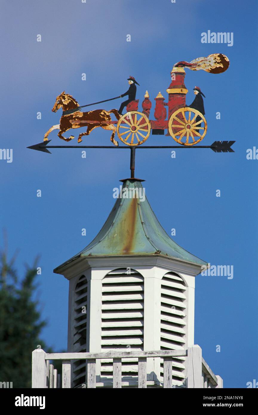 Fire wagon weather vane atop a cupola.; Brewster, Cape Cod, Massachusetts. Stock Photo