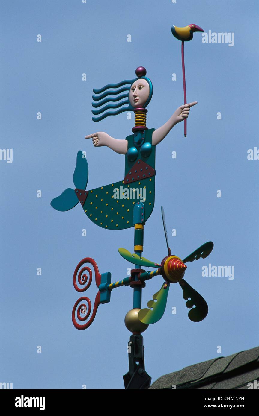 A colorful mermaid shaped weather vane.; Brewster, Cape Cod, Massachusetts. Stock Photo