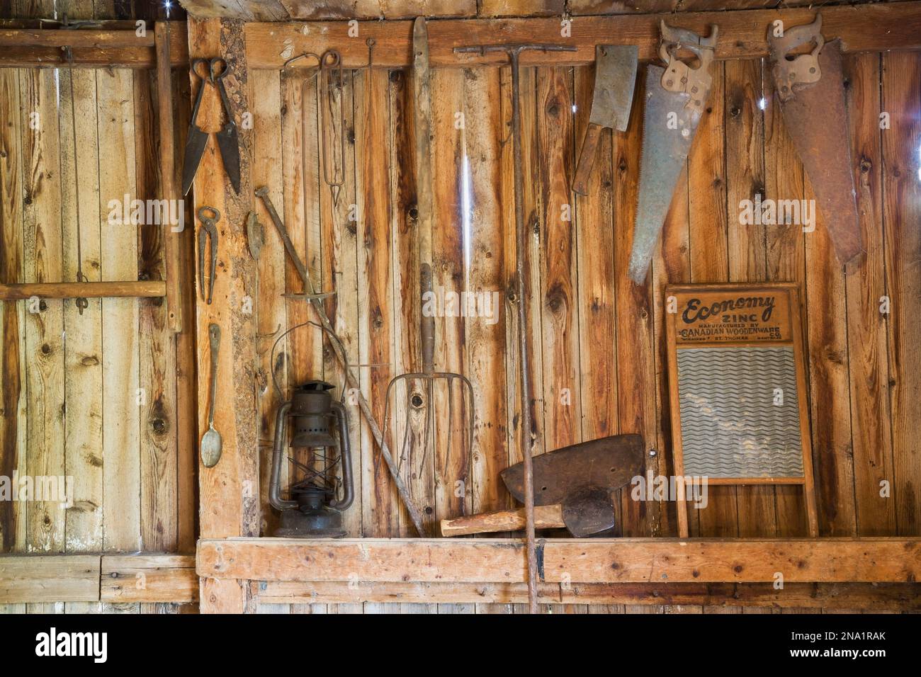 Antique oil lantern, pitchfork, shears, axe, saws, washboard and other