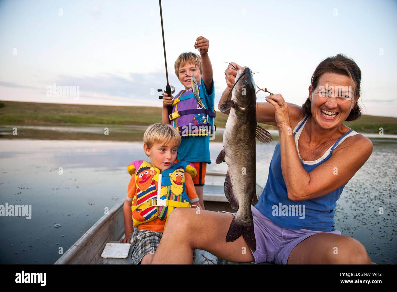 https://c8.alamy.com/comp/2NA1WH2/mother-and-two-young-sons-go-fishing-and-catch-fish-valparaiso-nebraska-united-states-of-america-2NA1WH2.jpg