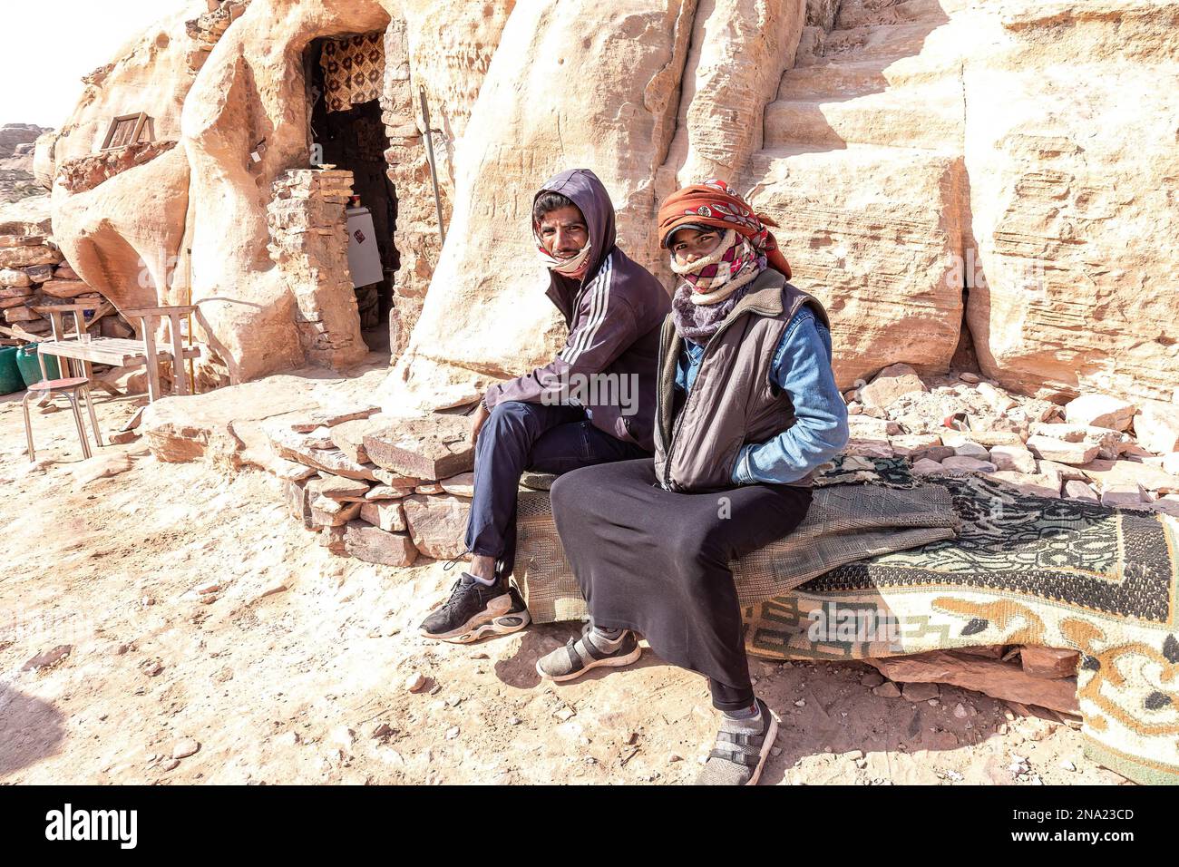 Bedouine sit in front of their shop that sells local handmade souvenirs