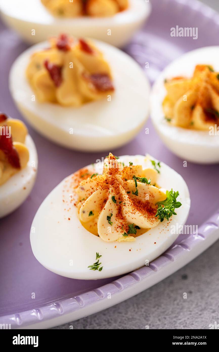 Deviled eggs with bacon and smoked paprika for Easter brunch Stock Photo