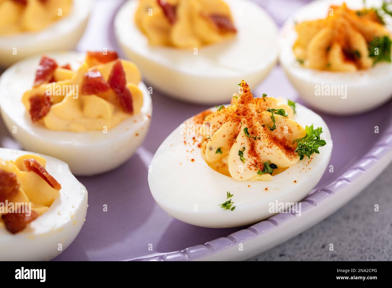 Deviled eggs with bacon and smoked paprika for Easter brunch Stock Photo