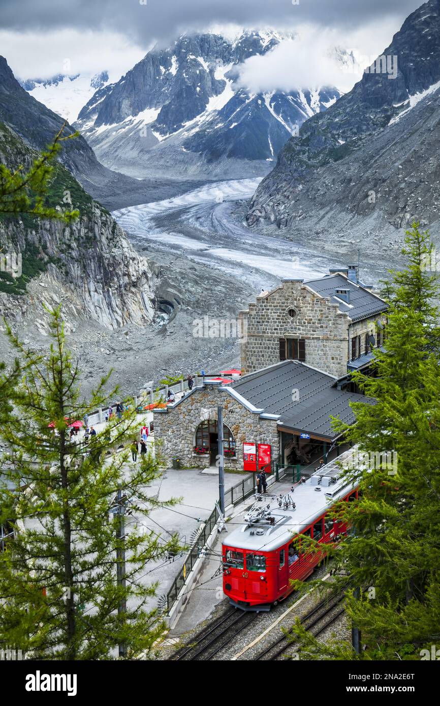 Montenvers train at Mer de Glace Station overlooks glacier and Grandes Jorasses; Chamonix-Mont-Blanc, Haute-Savoie, France Stock Photo