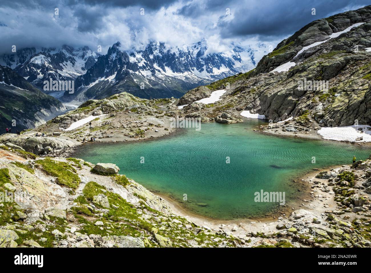 None Lac Blanc, looking towards Mont Blanc Massif and Mer de Glace under dramatic clouds; Chamonix-Mont-Blanc, Haute-Savoie, France Stock Photo