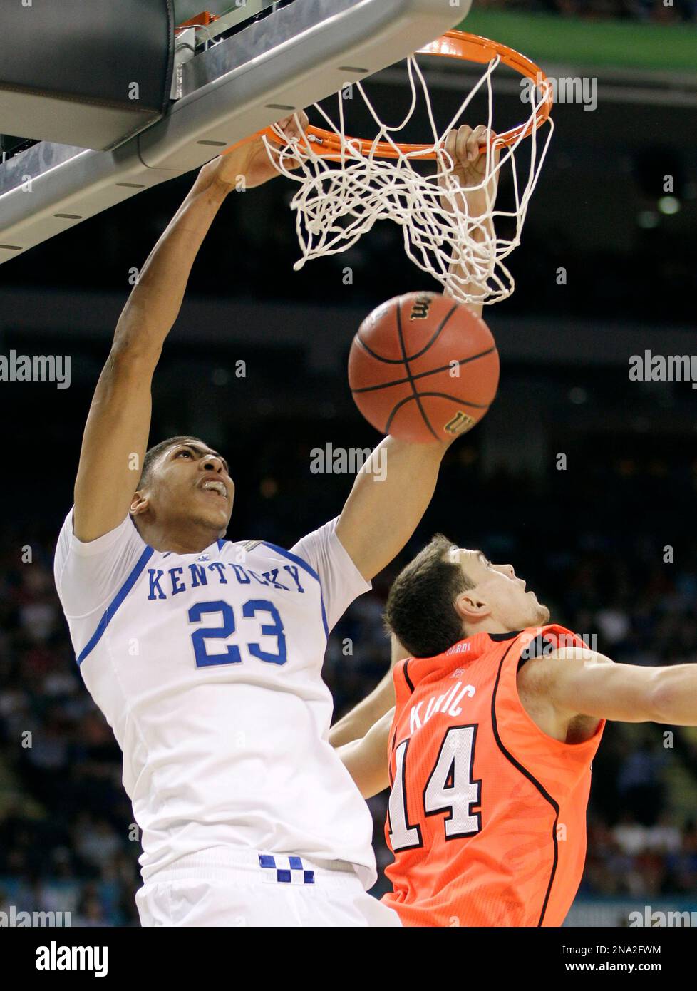 Kentucky's Anthony Davis (23) dunks the ball over Louisville's Kyle