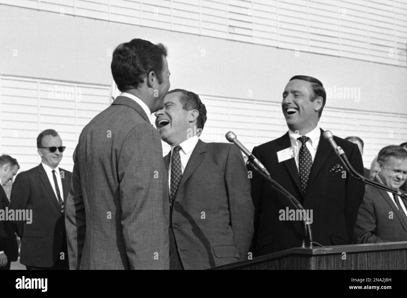 FILE - In this Oct. 10, 1968, file photo Republican presidential candidate  Richard Nixon, center, laughs at something comedian Dick Martin, right,  says, during a rally in Burbank, Calif., Oct. 10, 1968.