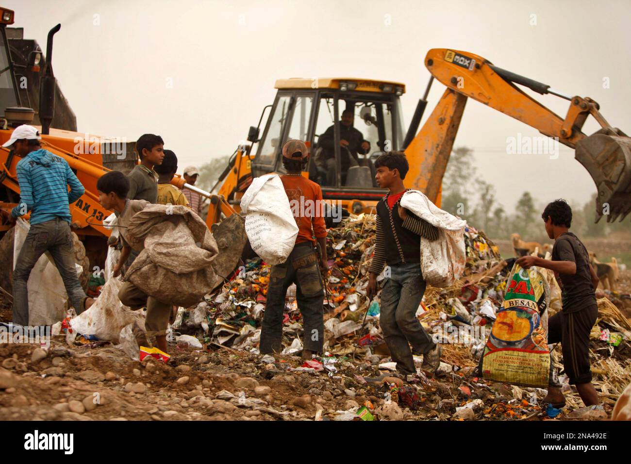Indian Rag Pickers Young rag pickers collect recyclable materials at a garbage dump in the ...