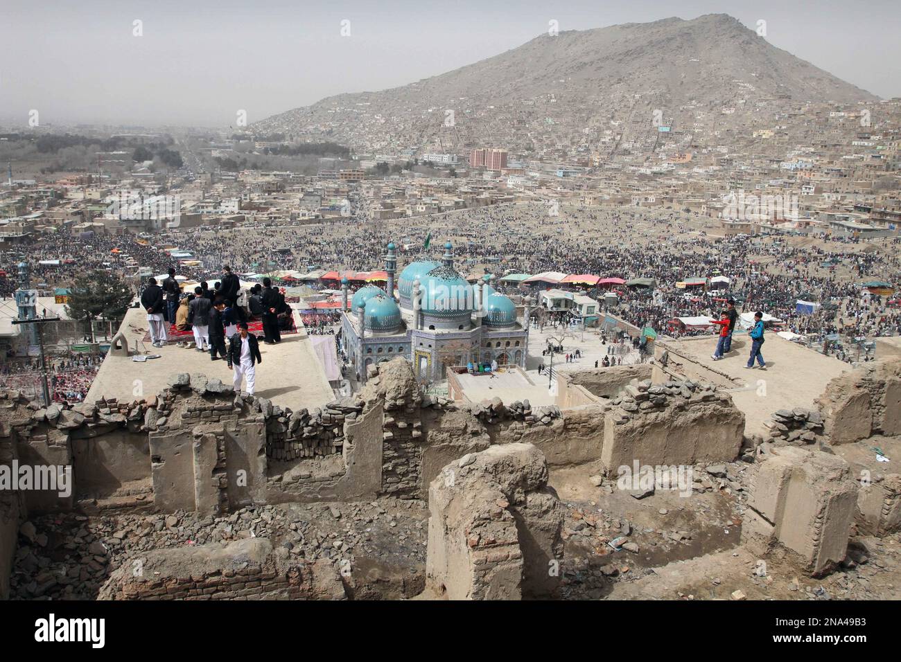 Afghans gather to watch the raising of the holy mace during a
