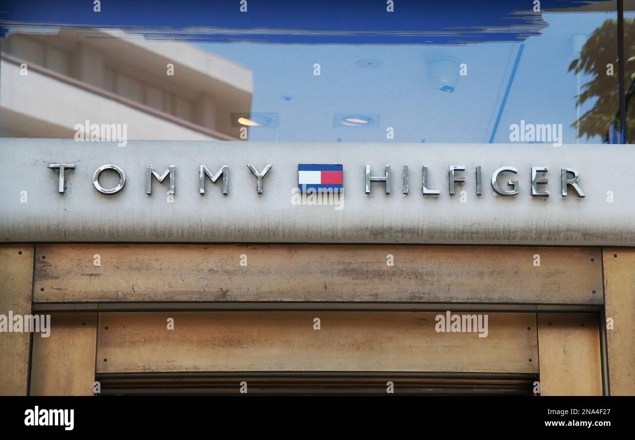 The logo of Tommy Hilfiger is seen in Shibuya Ward, Tokyo on May 29, 2022. Tommy  Hilfiger B.V. (Tommy Hilfiger Corporation / Tommy Hilfiger Inc.) is an  American clothing brand, manufacturing apparel,