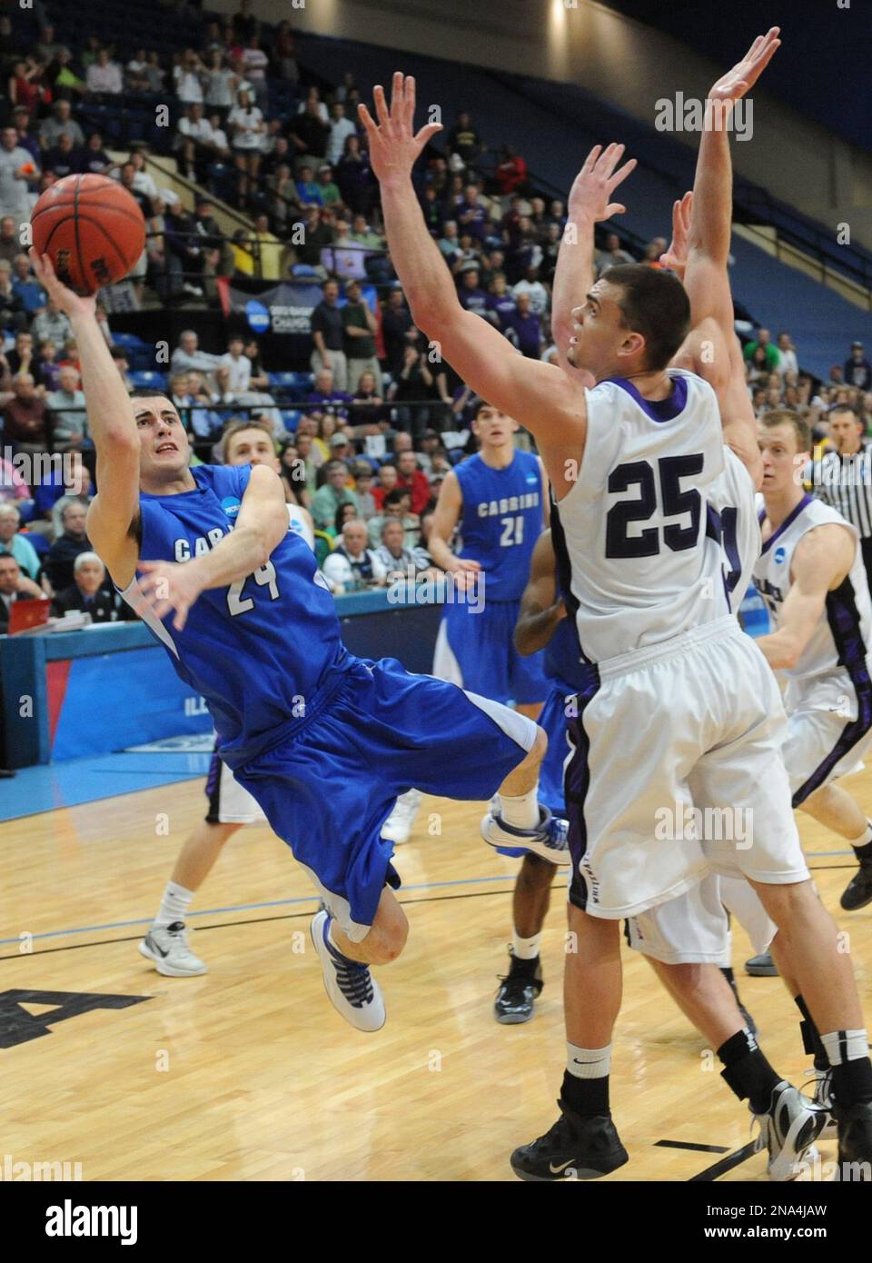 Cabrini's John Boyd, takes a shoot against Wisconsin-Whitewater's Alex  Edmunds, right, during the second half of the NCAA Division III  championship college basketball game at the Salem Civic Center in Salem,  Va.,