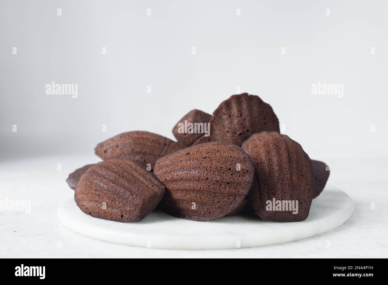Chocolate madeleines on a marble tray, plain chocolate madeleine cake