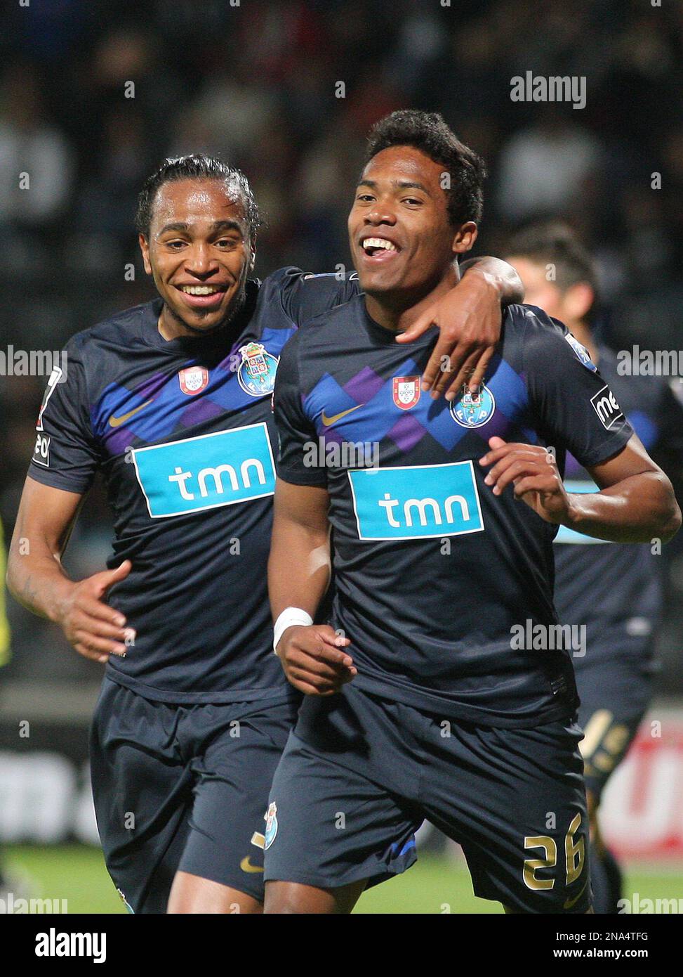 FC Porto's Alex Sandro, right, from Brazil celebrates with Alvaro Pereira,  from Uruguay, after scoring his team second goal against Nacional during  their Portuguese League soccer match at Nacional's stadium outside Funchal,