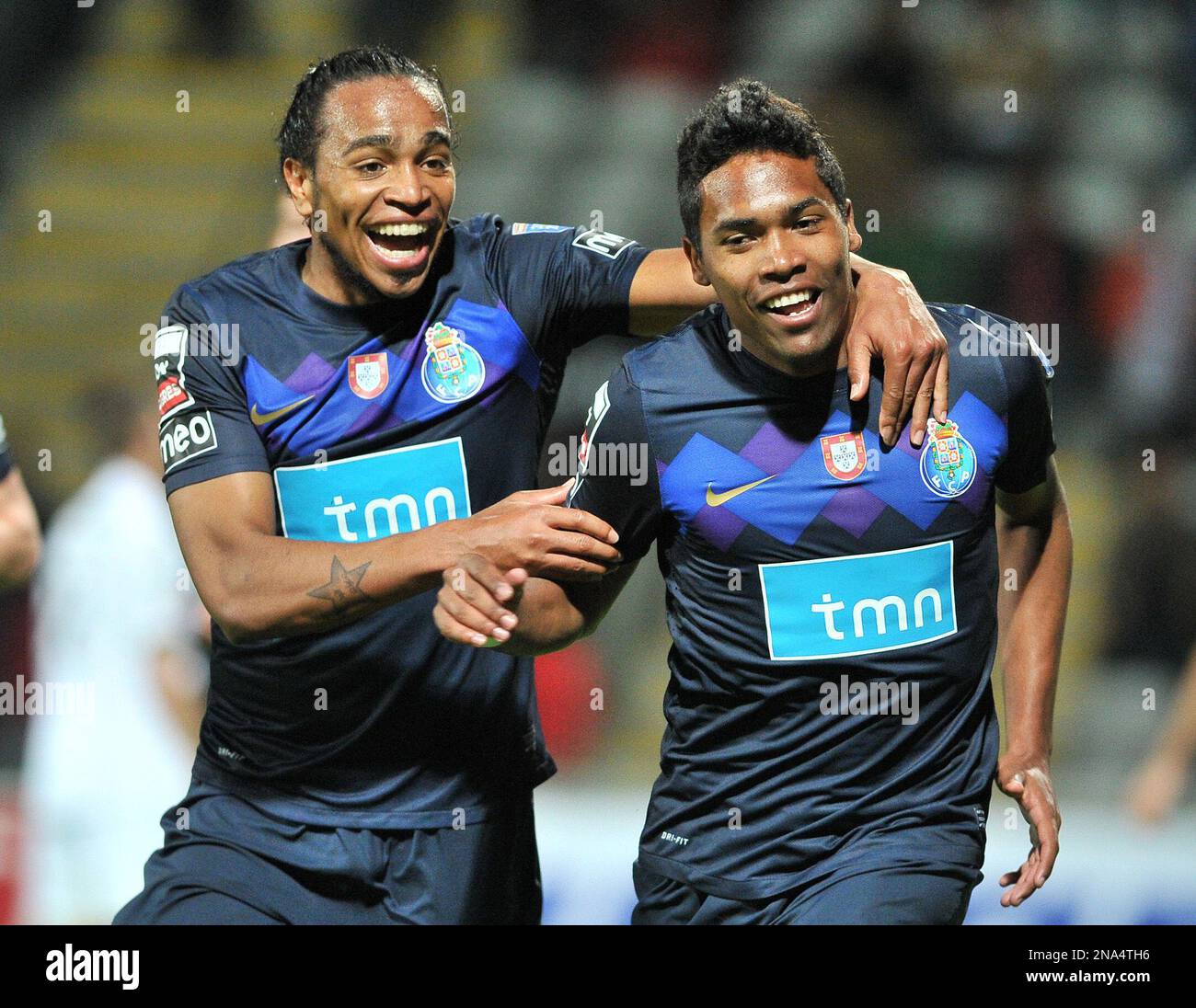 FC Porto's Alex Sandro, right, from Brazil celebrates with Alvaro Pereira,  from Uruguay, after scoring his team second goal against Nacional during  their Portuguese League soccer match at Nacional's stadium outside Funchal,