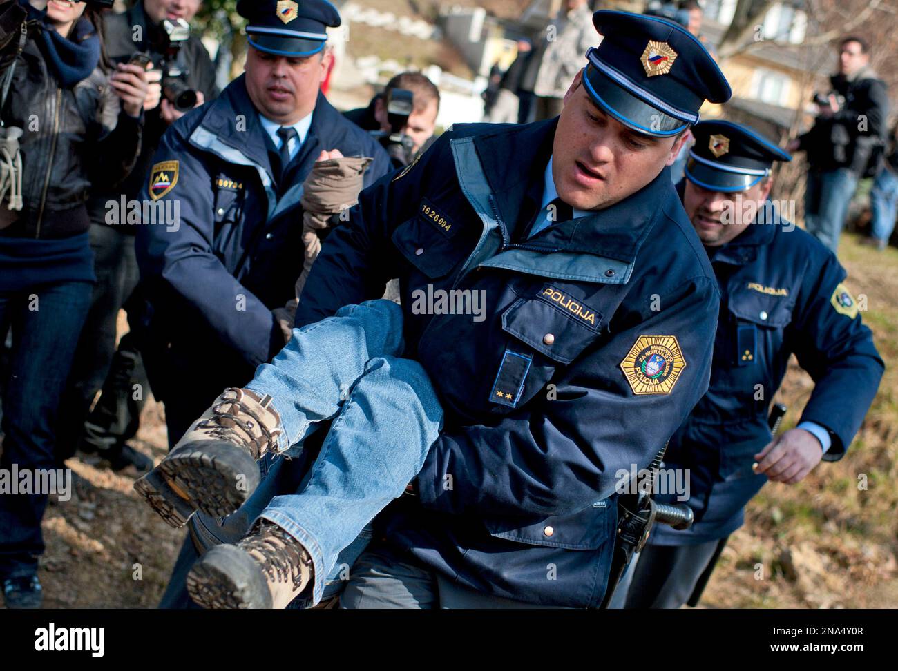 Police remove a protester in Litija, Slovenia, Friday, March 16, 2012.  Police have intervened against some two dozen activists who tried to  prevent the eviction of man whose house was put on