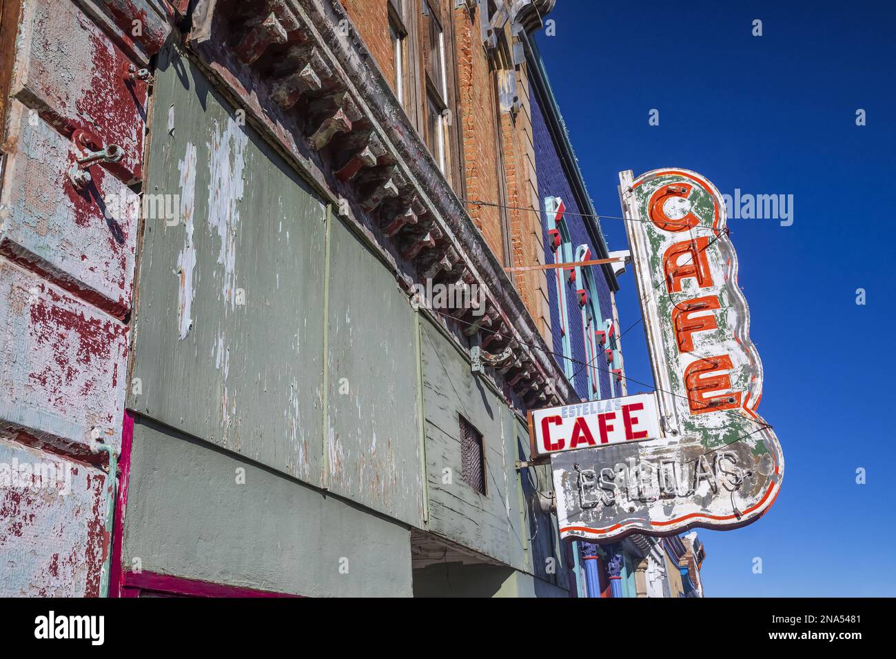 Old neon sign mounted on the exterior wall of an abandoned cafe; Raton ...