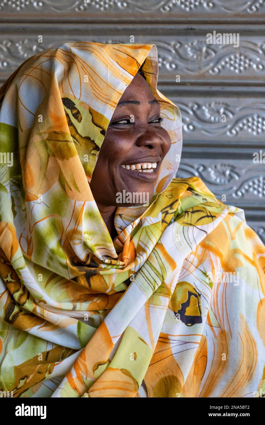 Portrait of a Sudanese woman with a big smile and colourful headscarf; Dongola, Northern State, Sudan Stock Photo