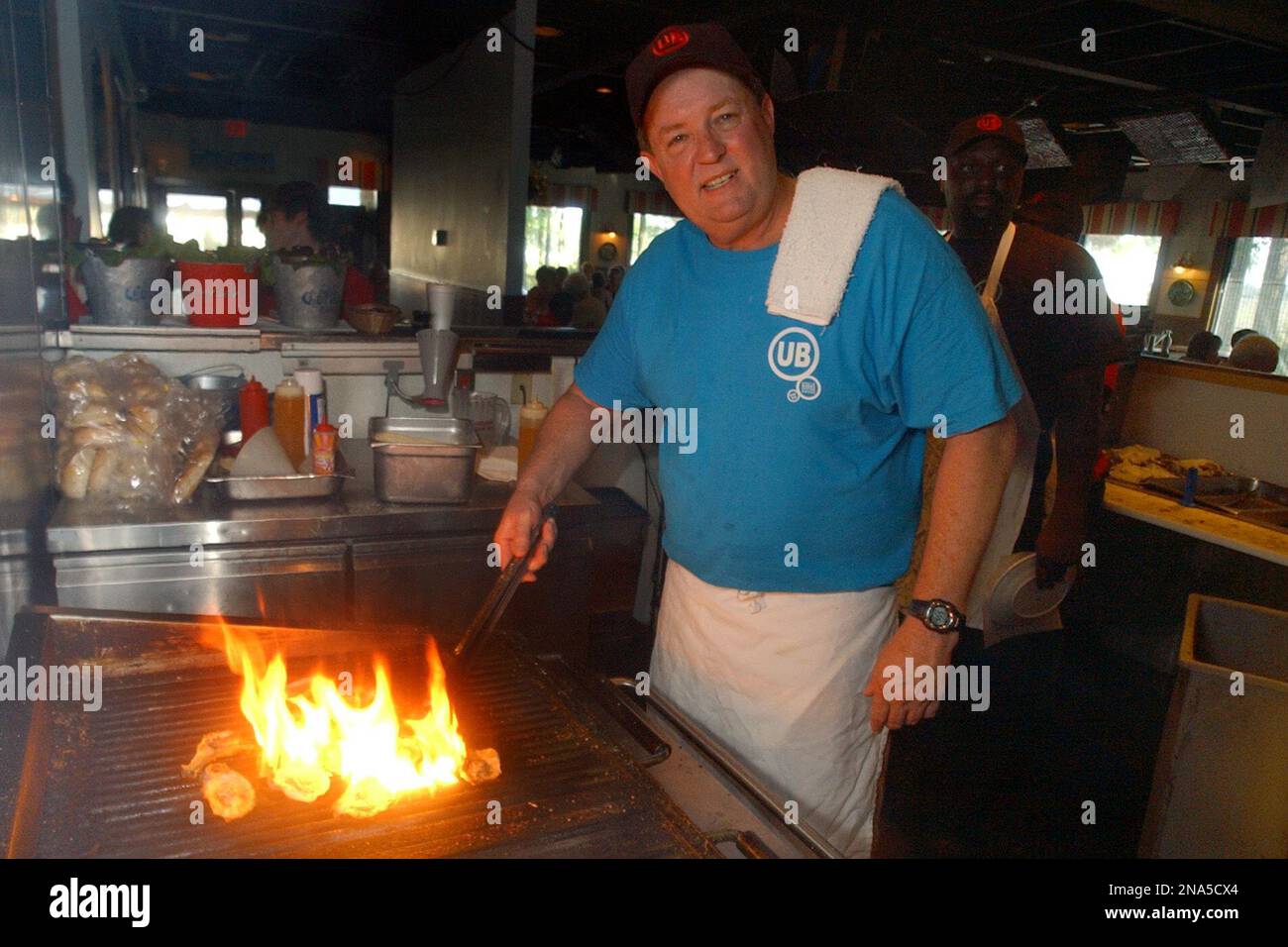 In this file photo, Bubba Hiers, who is Paula Deen’s brother, and chef and owner of Uncle Bubba's Oyster House, in Savannah, Ga. grills a dozen oysters Friday June 23, 2006. (AP Photo/Stephen Morton) Stock Photo