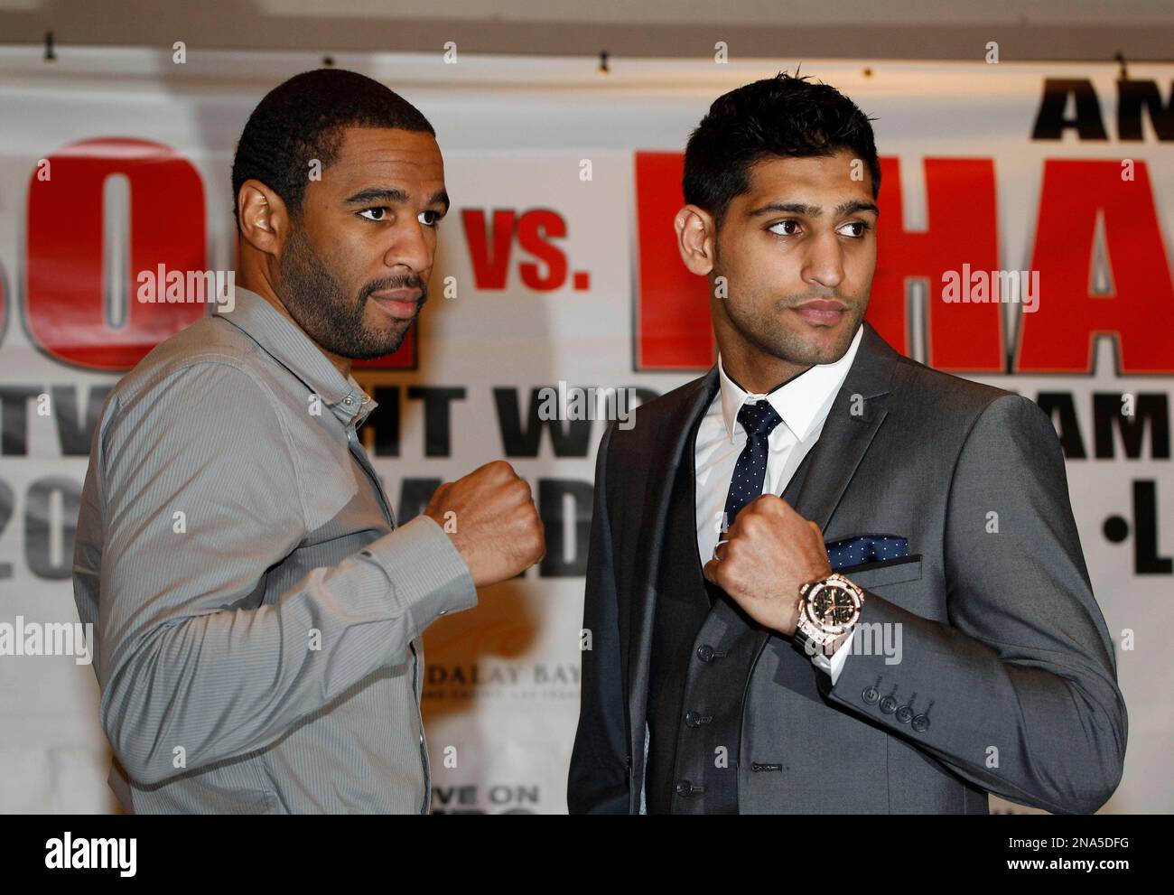 Light Welterweight World Champion US boxer Lamont Peterson, left, and British Boxer Amir Khan, pose for the photographers following a news conference in London, Tuesday, March 13, 2012