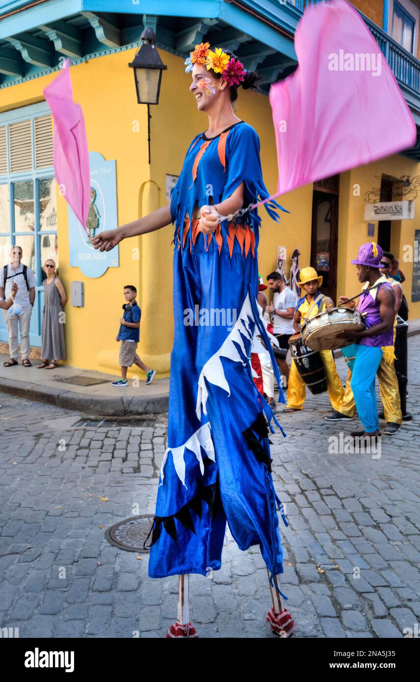 Stilt dancer and musicians in the street, Old Town; Havana, Cuba Stock Photo