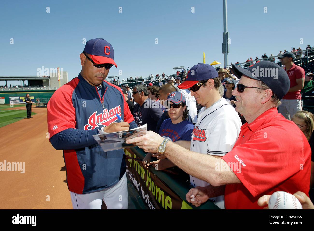 Former Cleveland Indians infielder Carlos Baerga signs for fans before a  spring training baseball game against the San Diego Padres Saturday, March  10, 2012, in Goodyear, Ariz. (AP Photo/Mark Duncan Stock Photo 