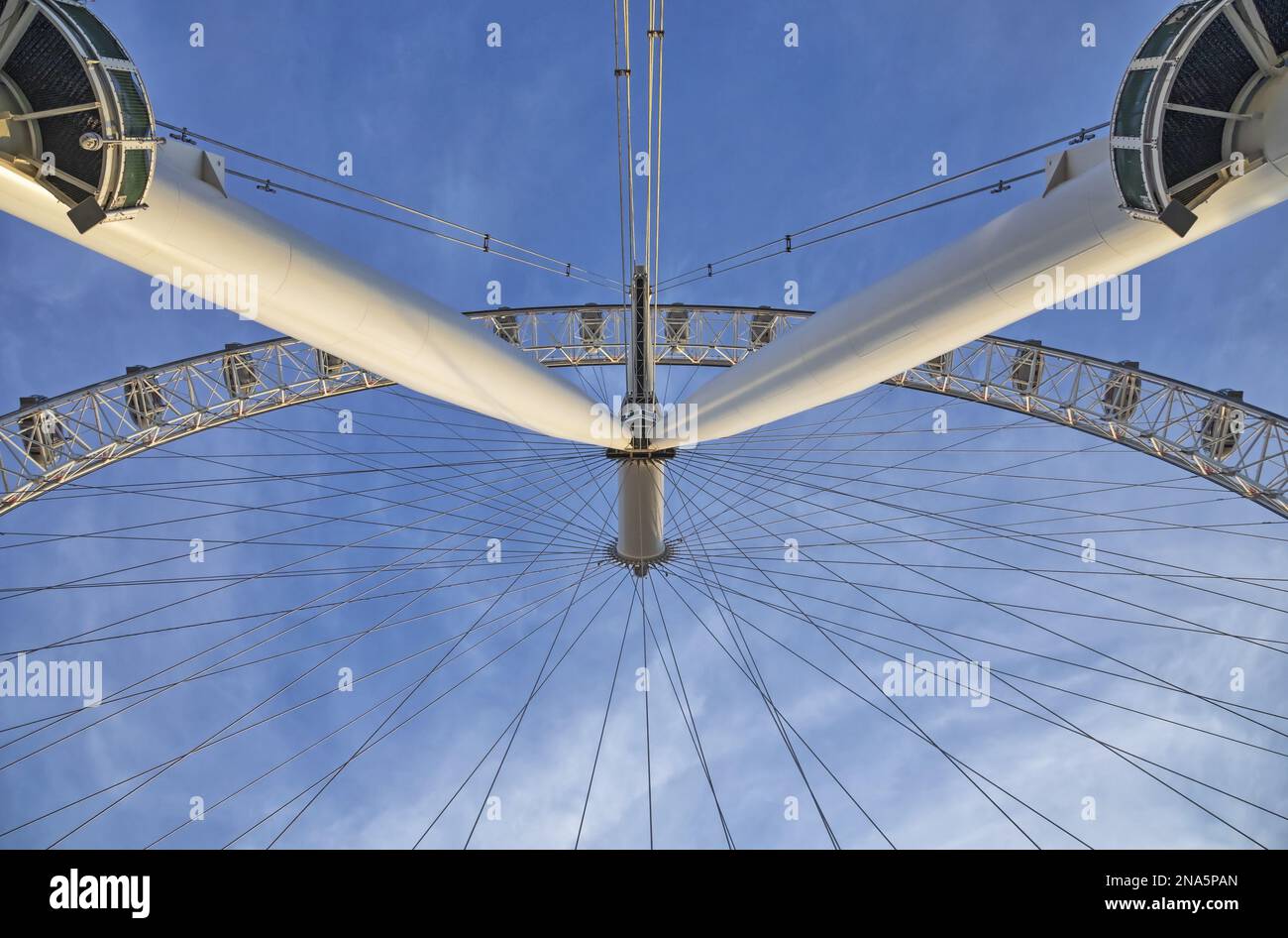View from directly below the cables and pods of the London Eye with a blue sky in the background; London, England Stock Photo
