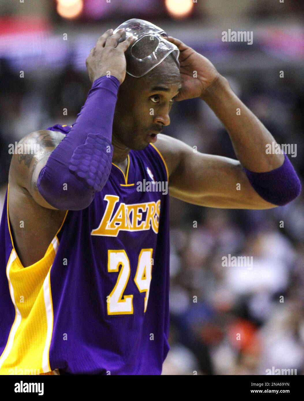 Los Angeles Lakers guard Kobe Bryant (24) removes his face