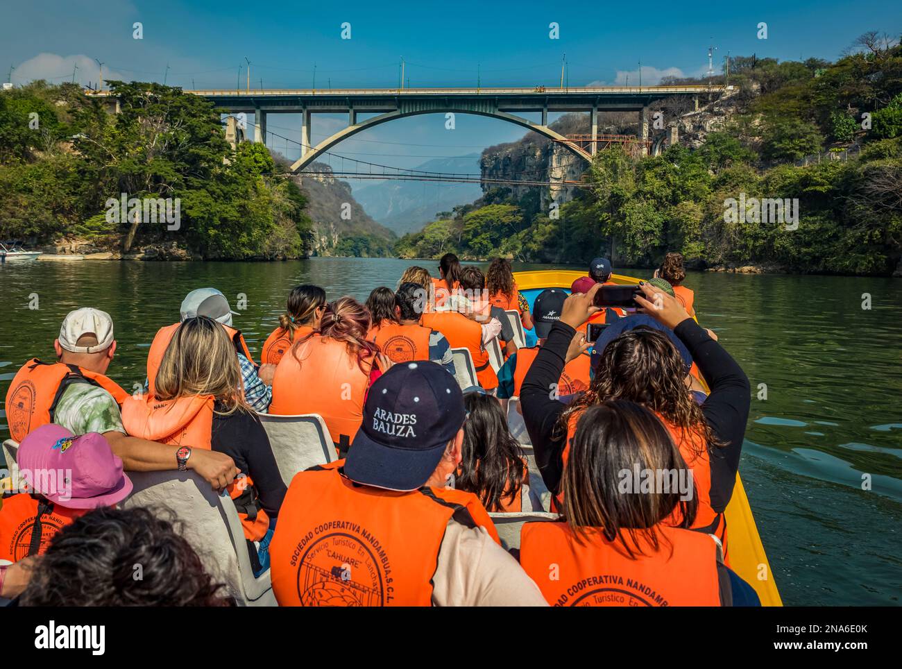 Tourists in a boat viewing Belisario Dominguez Bridge over Sumidero Canyon, Sumidero Canyon National Park; Chiapas, Mexico Stock Photo