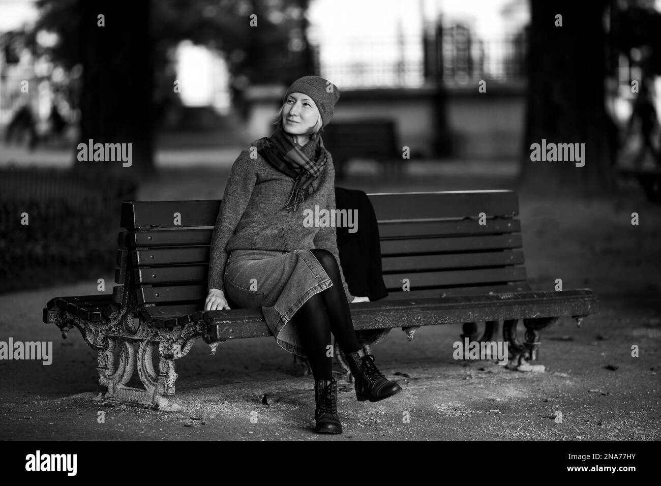 A woman on a park bench. Black and white photograph. Stock Photo