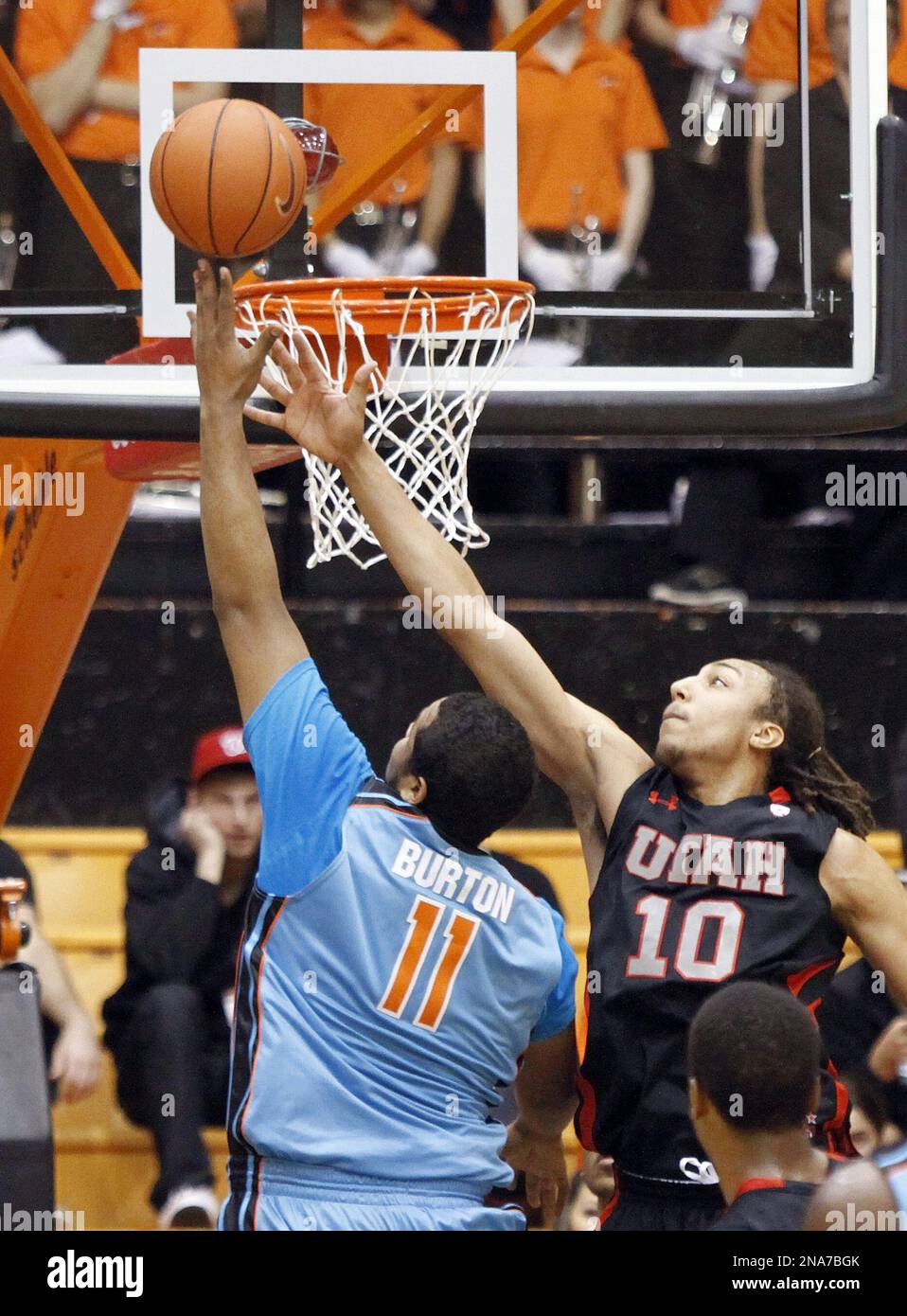 Oregon State center Joe Burton, left, shoots against Utah forward Dijon Farr during the first
